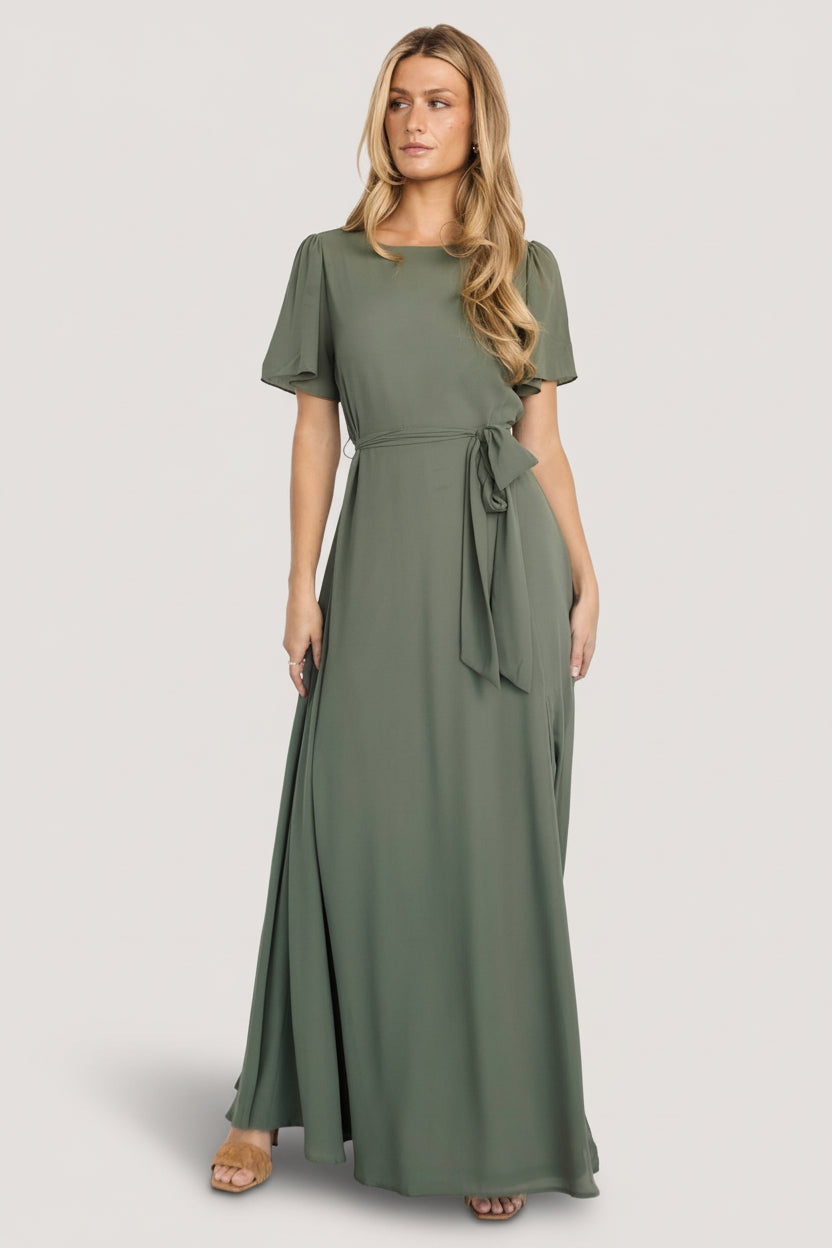 Flatlay and detail composition of Naomi chiffon maxi dress in dark sage showing sleeve silhouette, belt tie, and fabric drape for reference.