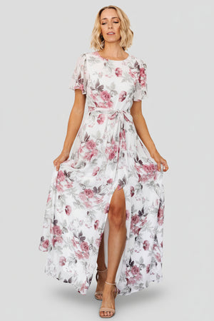Front view of Naomi off-white maxi dress with rose and sage floral print, rounded neckline, short flutter sleeves, and removable waist tie.