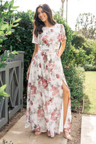 Close-up of chiffon fabric and short flutter sleeve on Naomi dress, highlighting rose and sage floral print and lightweight texture.