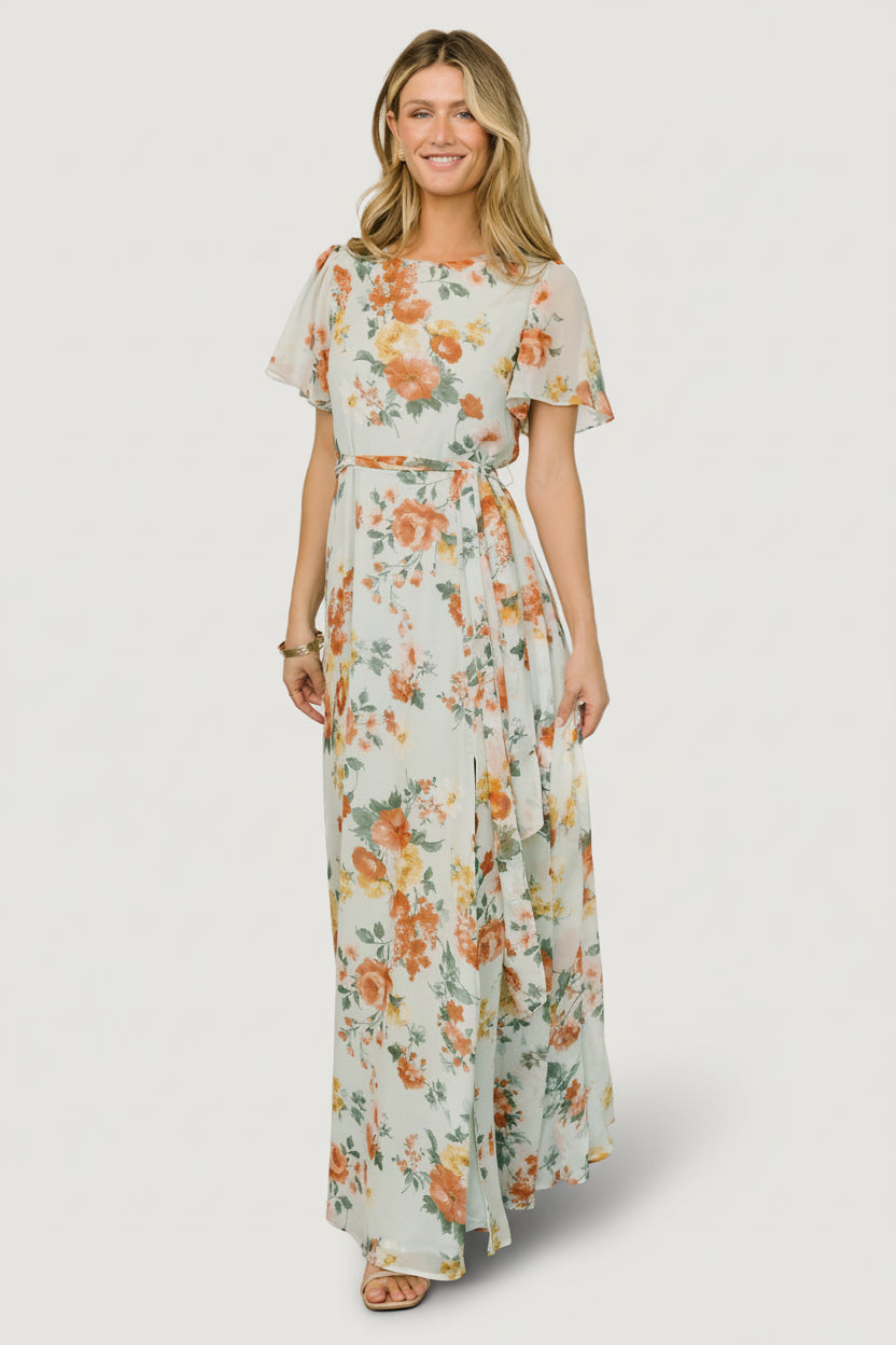 Front view of sage floral chiffon maxi dress with rounded neckline, short flutter sleeves, removable waist tie, and flowing hem for movement.
