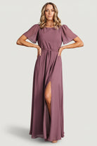Front view of Naomi chiffon maxi dress in vintage plum on model, rounded neckline, removable waist tie, and flowing skirt sweeping to maxi length.