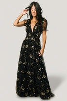 Detail image of the high banded waist and fabric drape showing how the waist defines shape and supports the full maxi skirt.