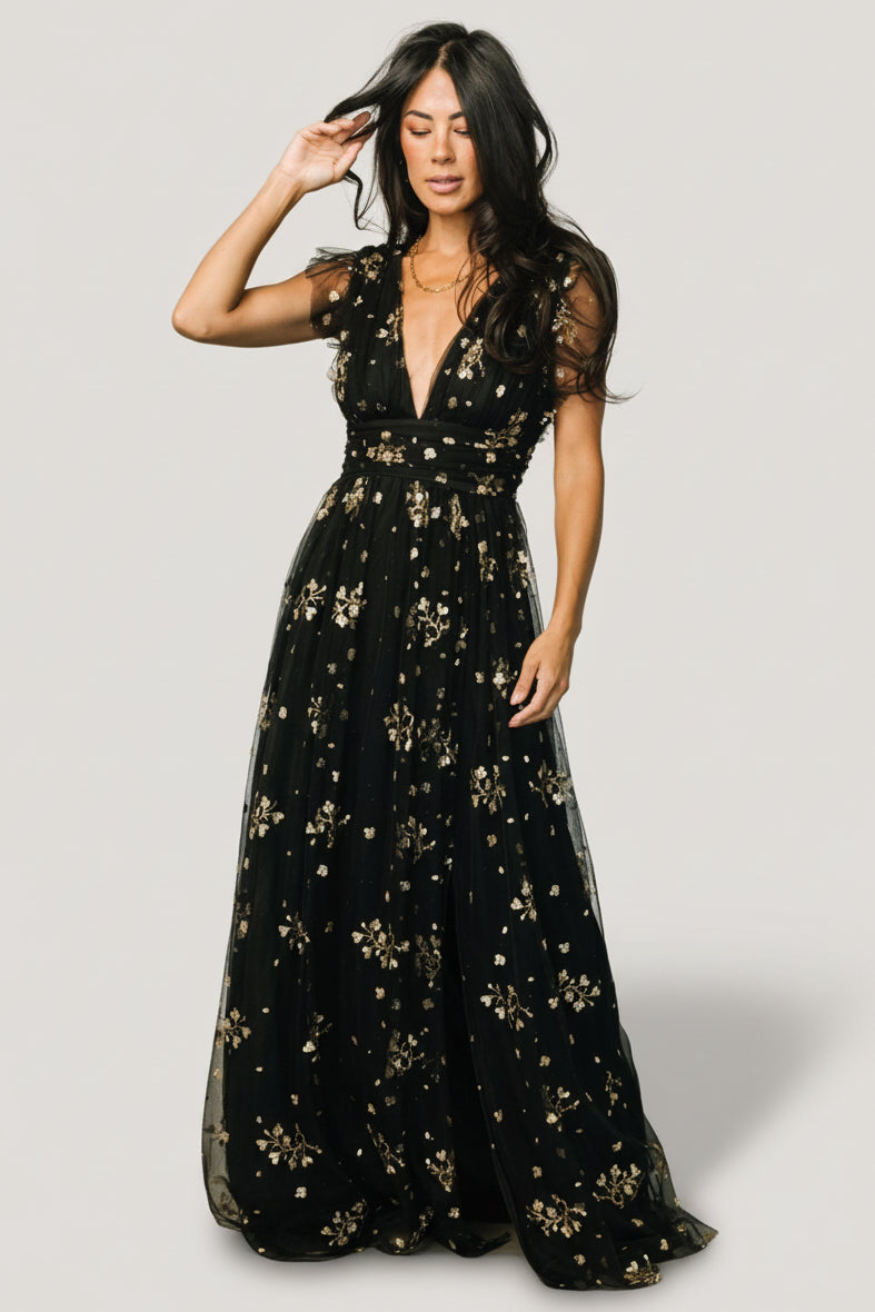 Detail image of the high banded waist and fabric drape showing how the waist defines shape and supports the full maxi skirt.