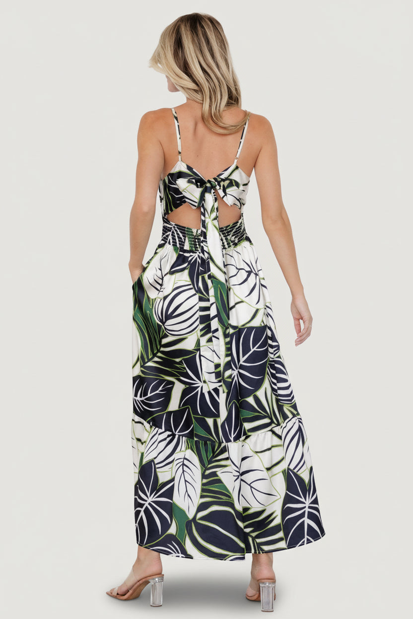 Back view highlighting the open back, smocked back waist and tie sash of the Norita midi dress in tropical print.