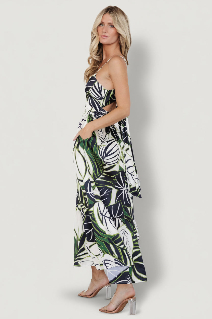 Side view of Norita dress illustrating hidden side pocket and relaxed silhouette with tiered skirt in tropical print.