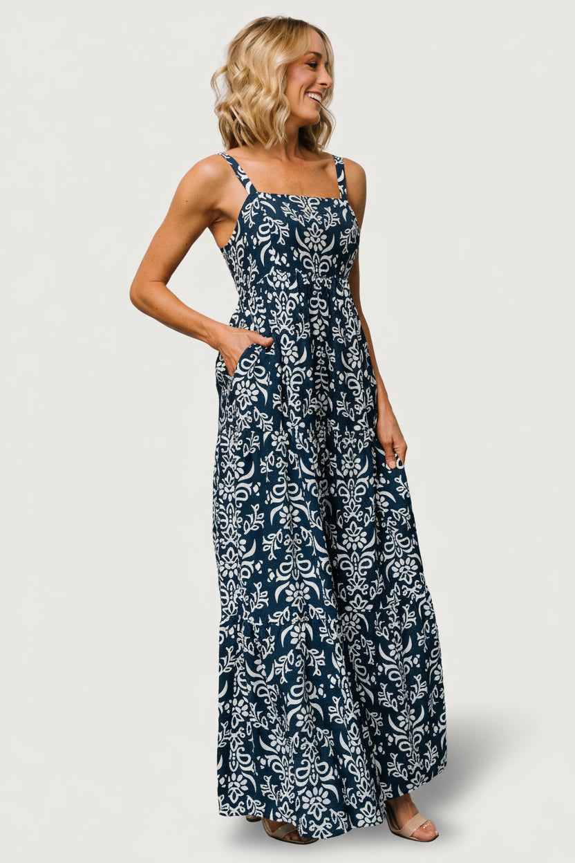Detail shot of tiered maxi skirt and hidden side pocket, illustrating the dress's flowy silhouette and travel-friendly, lined construction.