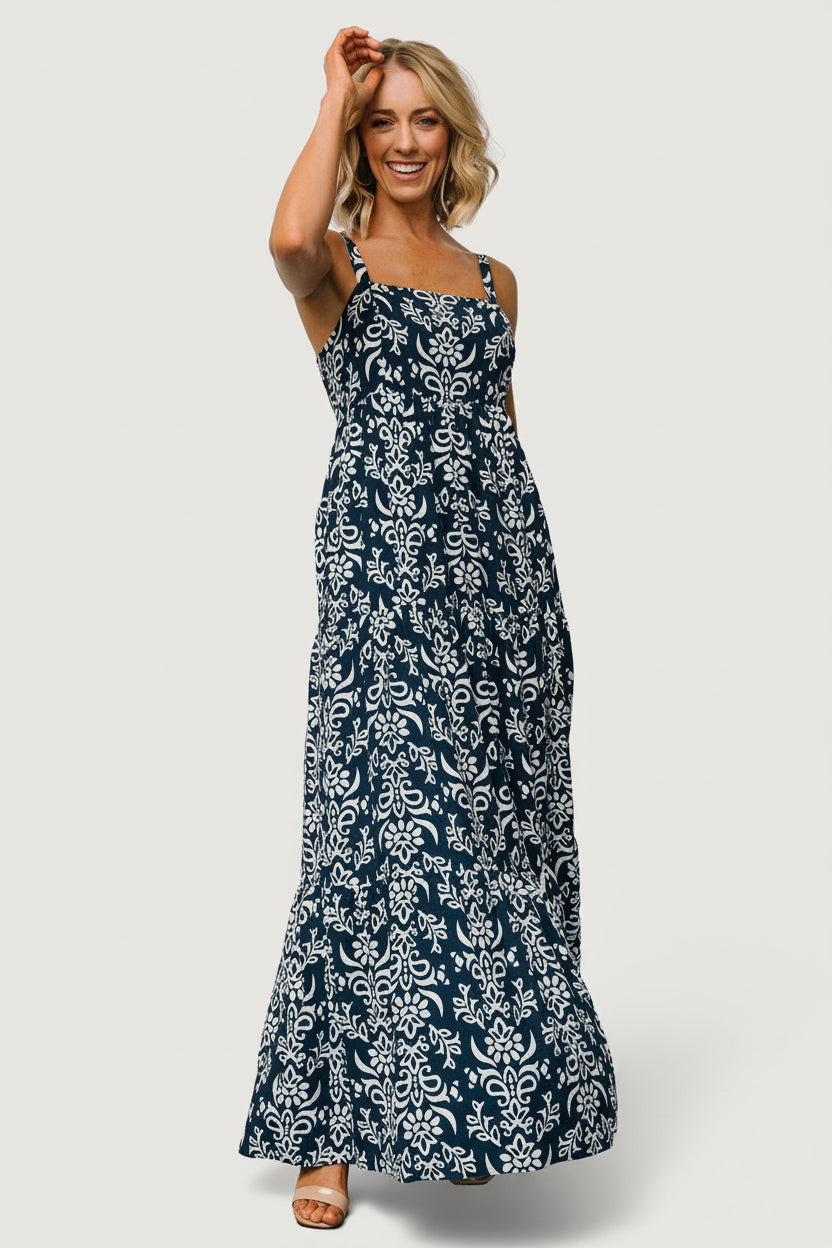 Styled look on model wearing the navy print maxi dress, showing overall length, fit and the dress's resort-ready aesthetic with practical pockets.