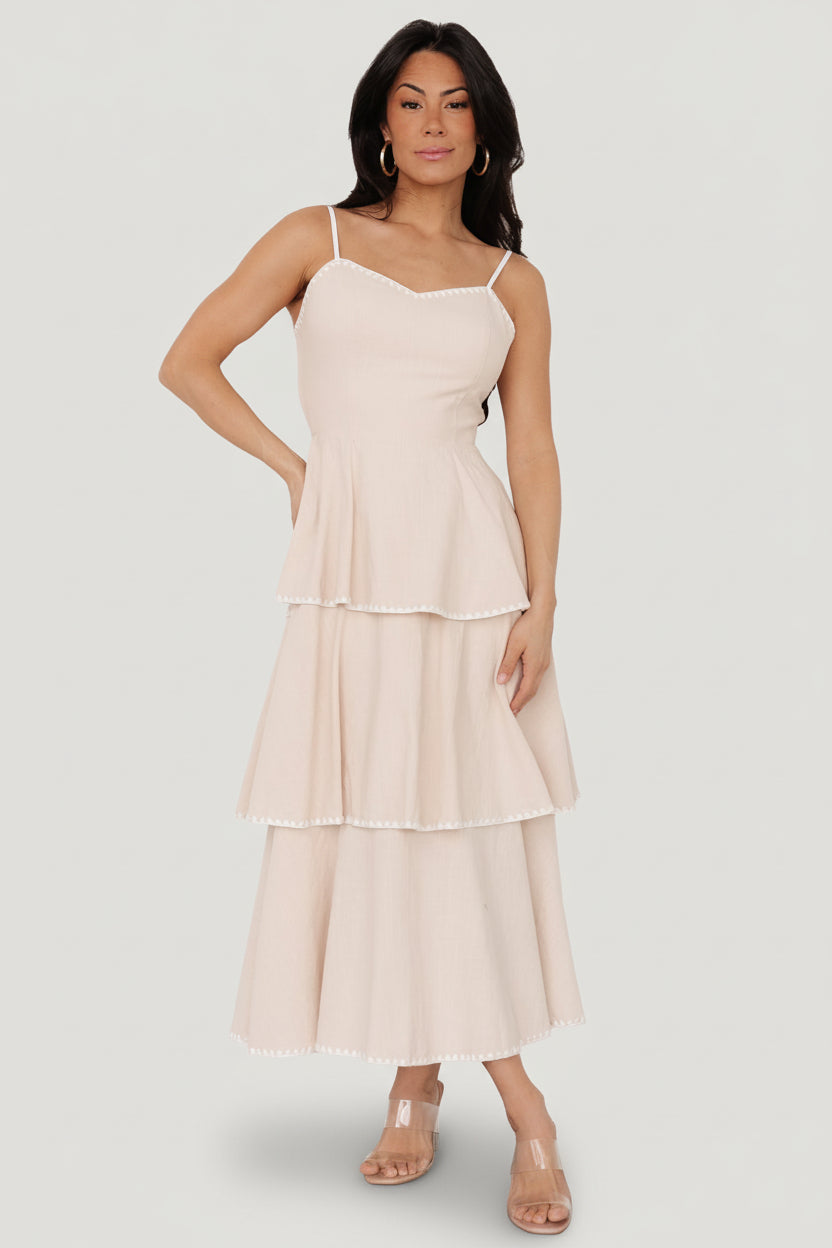 Front view of Odette tiered midi dress in natural with white embroidered triangle accents and adjustable spaghetti straps.