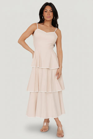 Front view of Odette tiered midi dress in natural with white embroidered triangle accents and adjustable spaghetti straps.