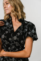 Close-up of textured 100% cotton fabric and floral print on the Odeya tiered midi dress.