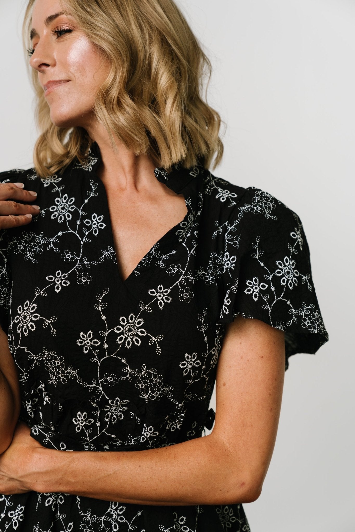 Close-up of textured 100% cotton fabric and floral print on the Odeya tiered midi dress.