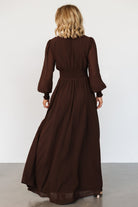 Movement shot of Olivia maxi dress in deep espresso brown, highlighting lightweight chiffon and full-length hem.