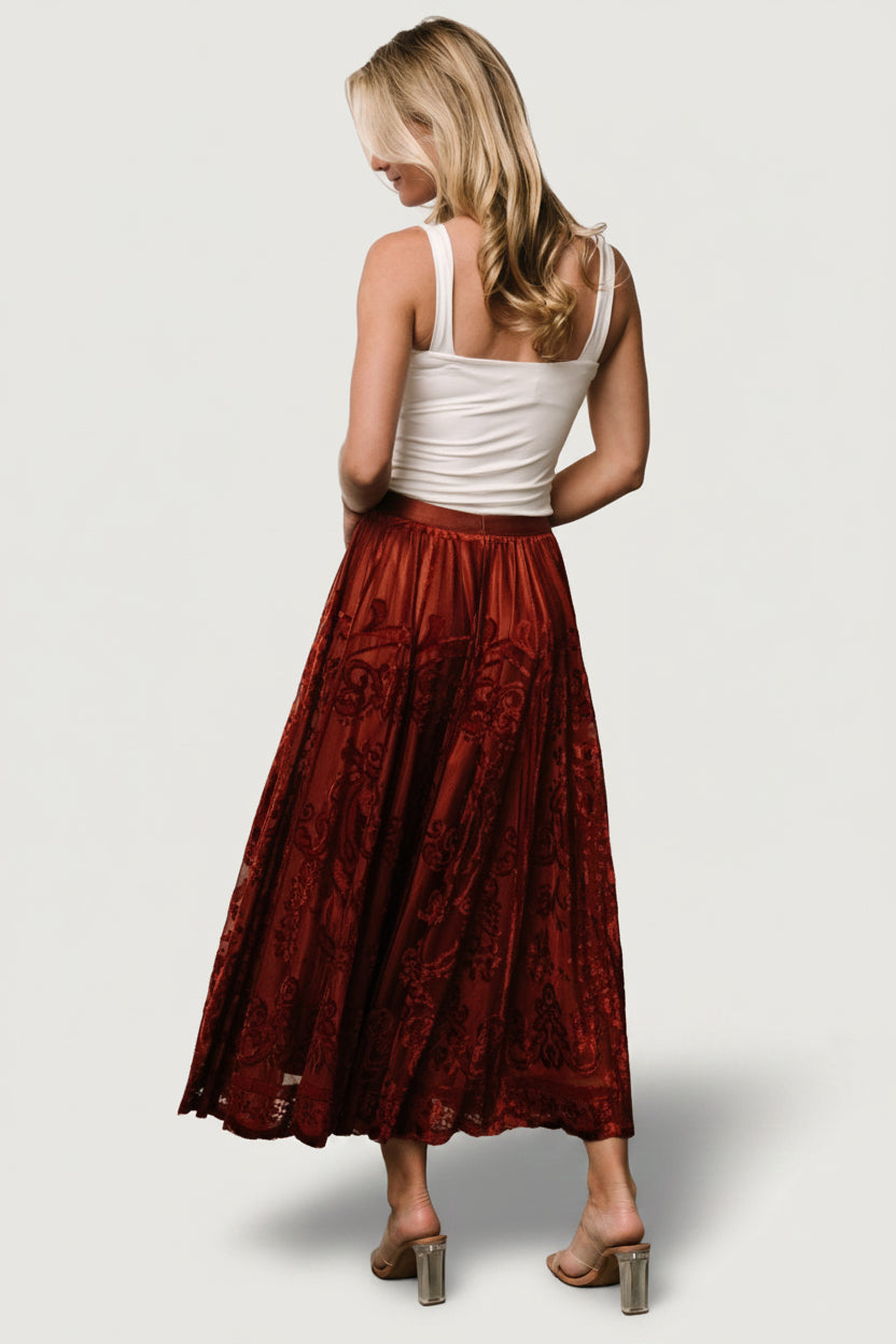 Side view of Palini Velvet Skirt in rust demonstrating drape, movement, and elastic waistband detail.