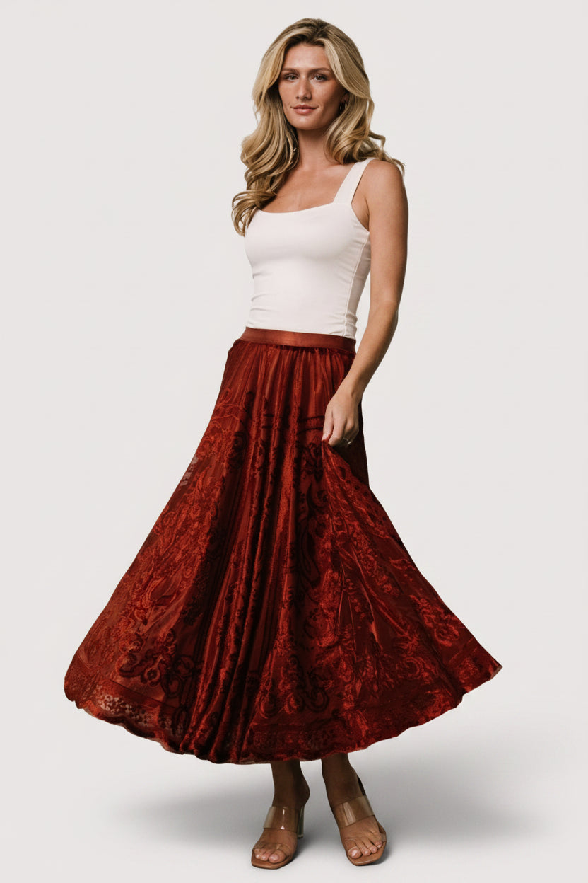 Full-length photo of Palini Velvet Skirt in rust on model, highlighting midi length, velvet burnout texture, and silhouette.