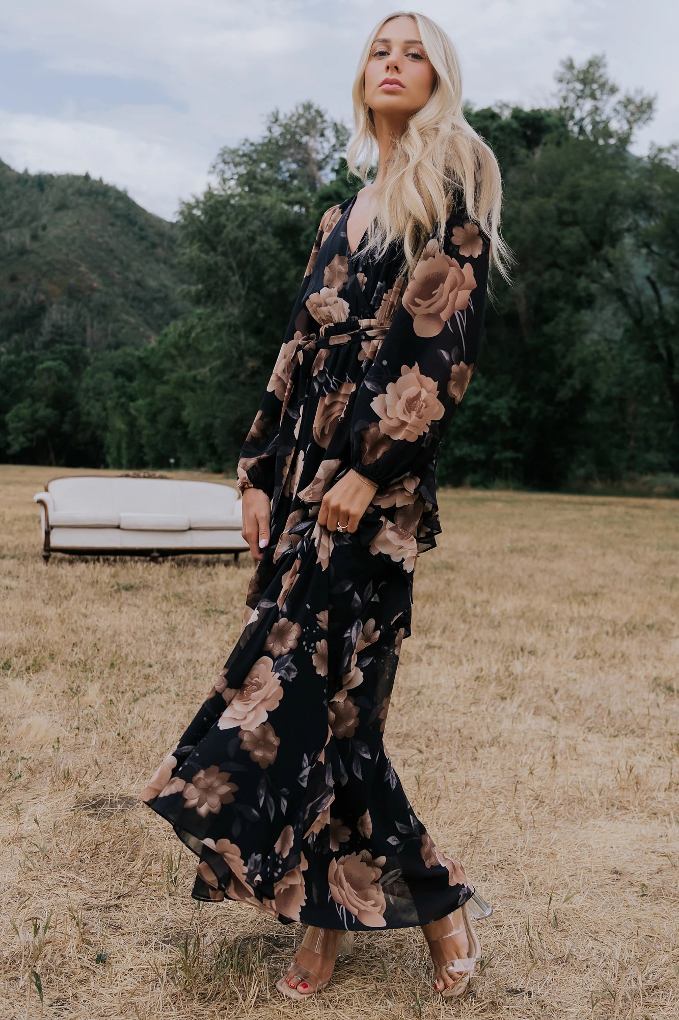 Phaedra Maxi Dress in Black + Taupe Floral with surplice V-neck, long sleeves, sash waist, and tiered skirt.