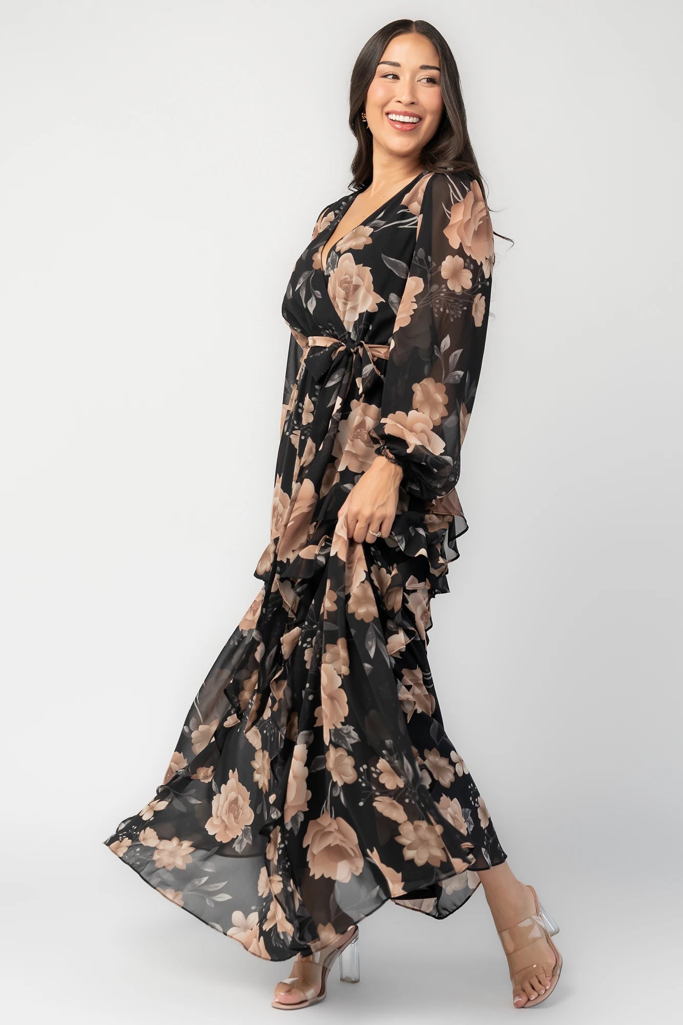 Phaedra Maxi Dress in Black + Taupe Floral with surplice V-neck, long sleeves, sash waist, and tiered skirt.