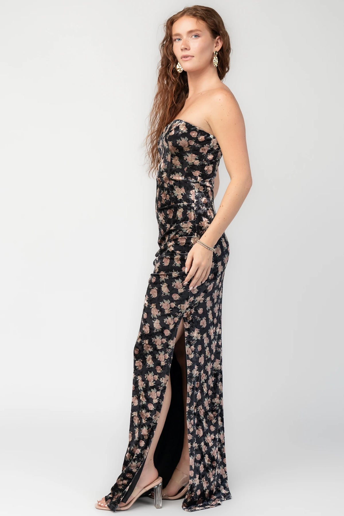 Philippa Velvet Maxi Dress in Black Floral with strapless neckline, side ruching, thigh-high slit, and floral velvet.