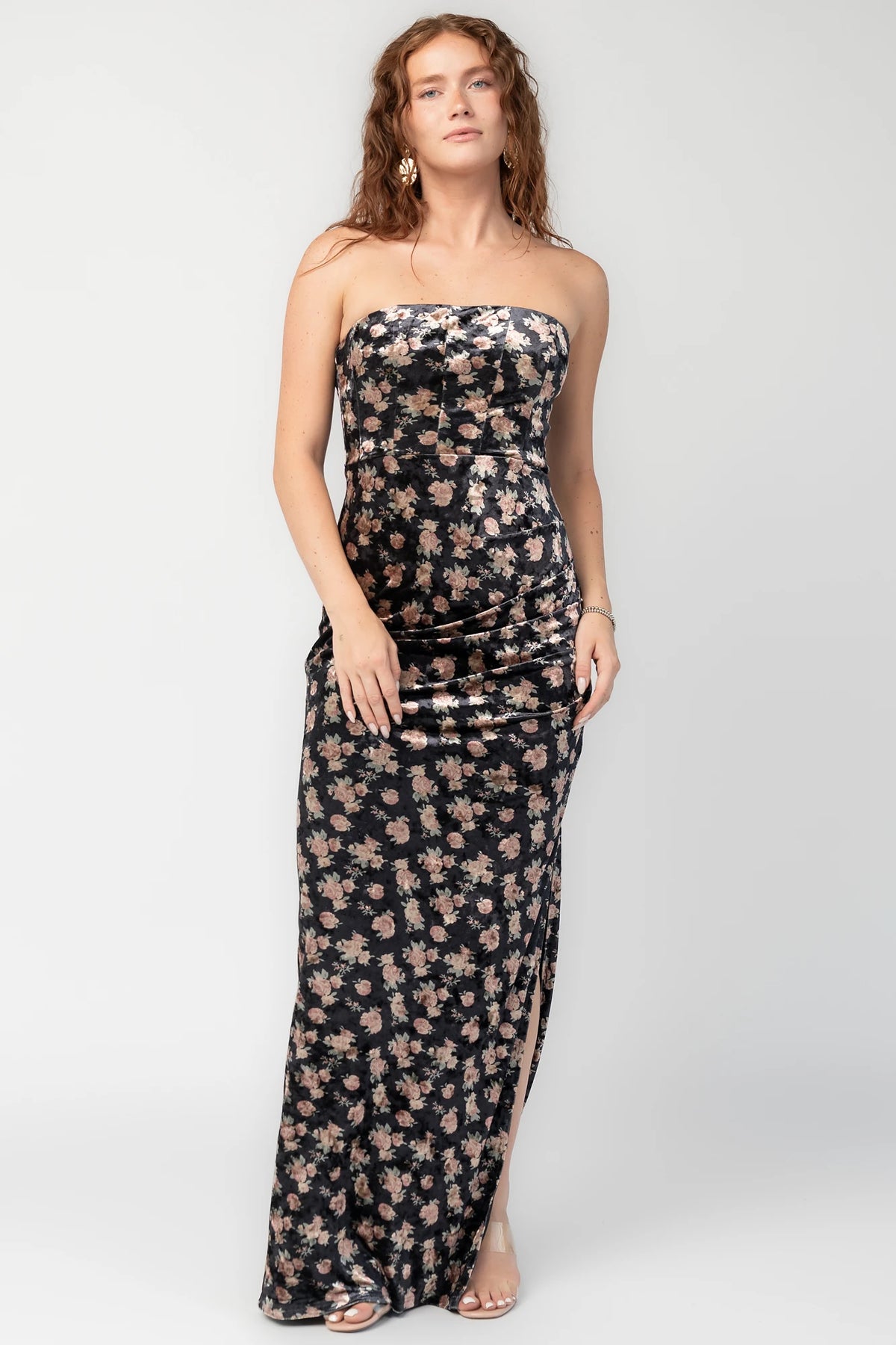 Philippa Velvet Maxi Dress in Black Floral with strapless neckline, side ruching, thigh-high slit, and floral velvet.