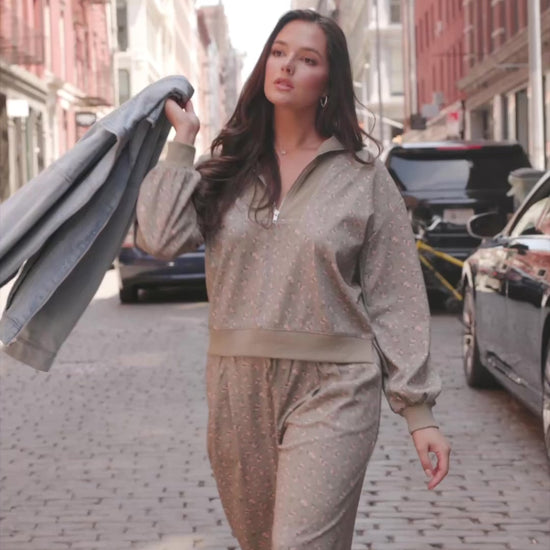 Model wearing the Diana Lounge Set in Olive Floral featuring a matching long-sleeve half-zip top and wide-leg pants.