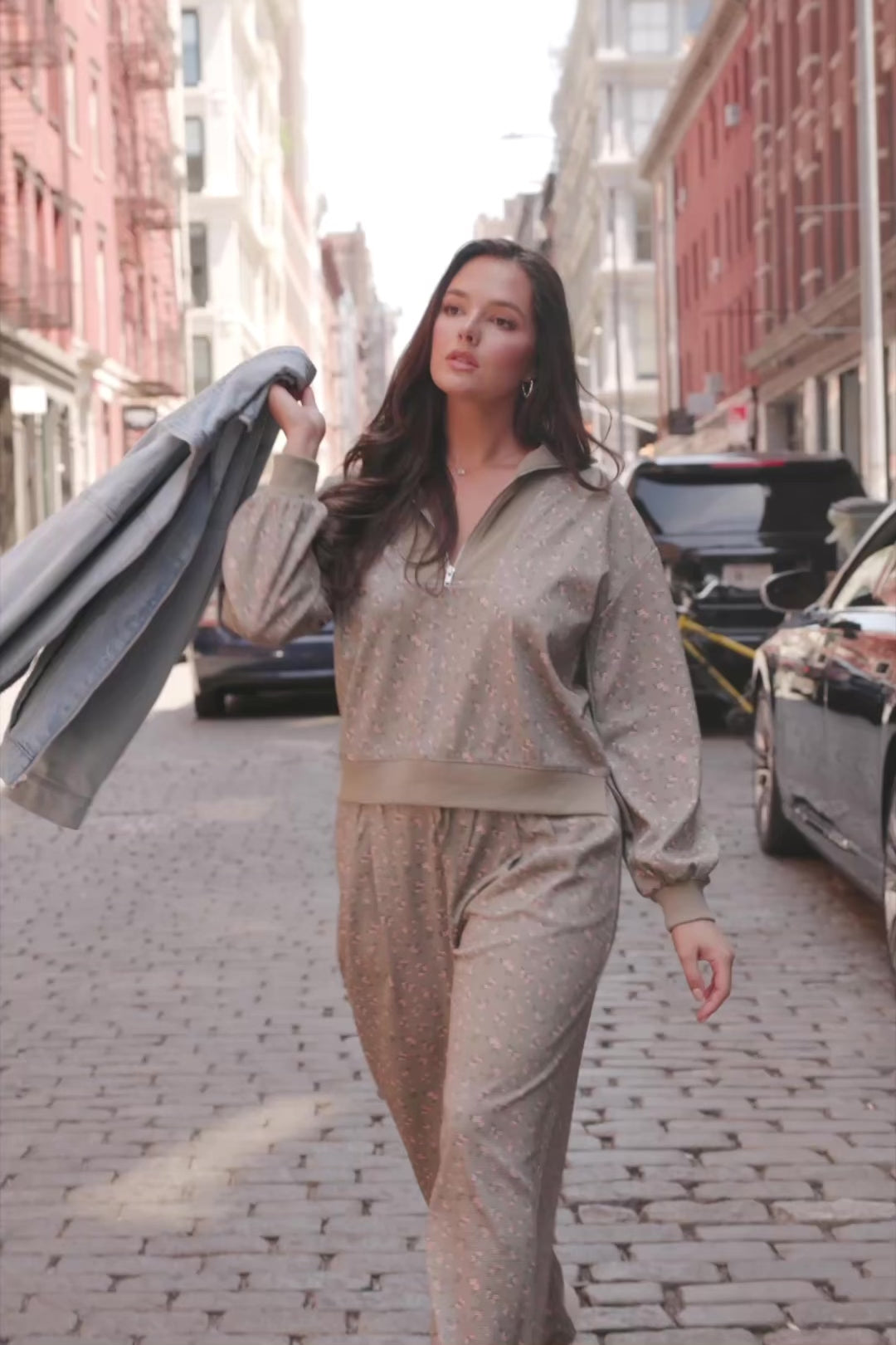 Model wearing the Diana Lounge Set in Olive Floral featuring a matching long-sleeve half-zip top and wide-leg pants.