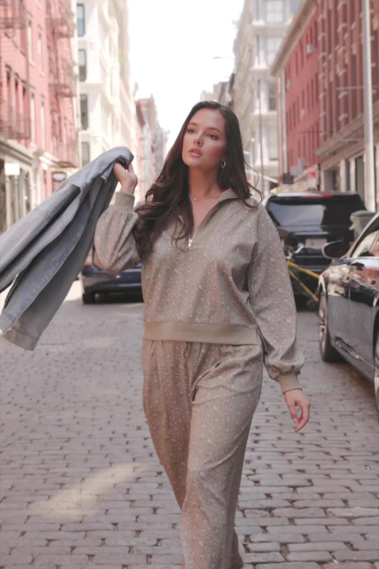 Model wearing the Diana Lounge Set in Olive Floral featuring a matching long-sleeve half-zip top and wide-leg pants.