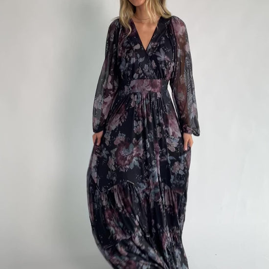 Midnight floral mesh maxi dress with sheer long sleeves, surplice V-neck, elastic waist with self-tie belt, tiered skirt, and keyhole back.