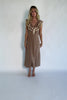 Model wearing a dusty mocha and cream plaid midi dress with a V-neckline, decorative bow tie detail, cascading ruffle trim, and a fitted silhouette.