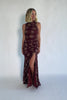 Model wearing a mahogany floral maxi dress with a high neckline, sleeveless fitted bodice, and ruched side detailing.