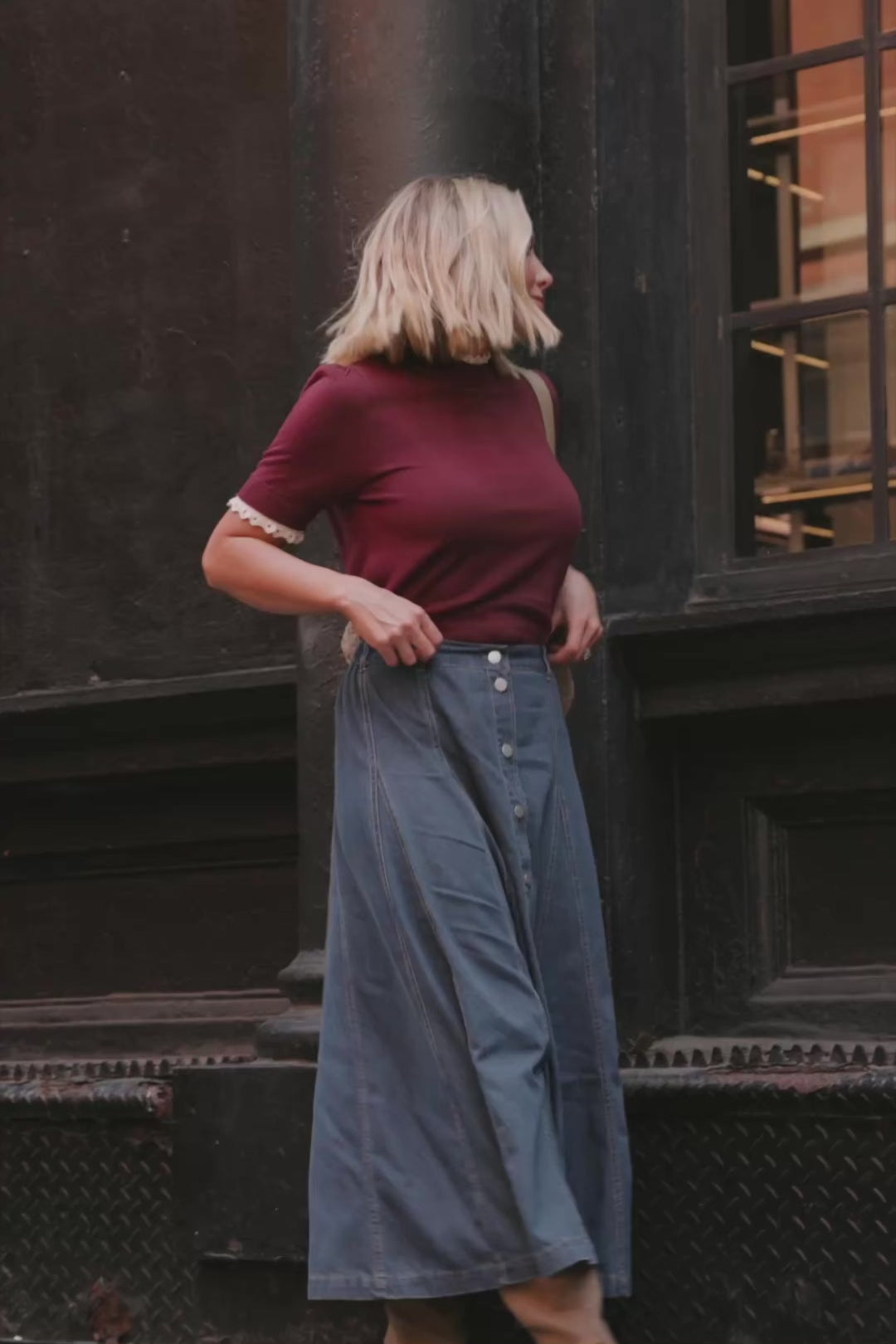 Model wearing the Adeline Sweater Top in Wine featuring a mock neckline, short sleeves with gathered shoulders, contrast ivory eyelet ruffle trim at the neckline and cuffs, and a classic fitted knit silhouette.