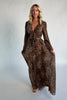 Model wearing a maxi dress with a mixed animal print, featuring a V-neckline with a keyhole cutout and front tie detail.