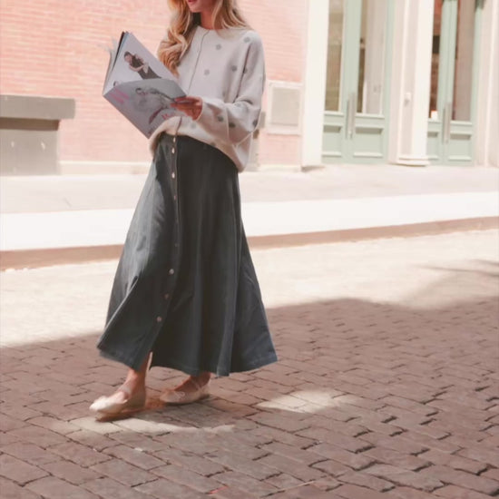 Model wearing the Cece Button-Down Denim Skirt in a dark wash featuring a button-front placket, elastic back waist, and a classic knee-length silhouette.