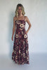 Model wearing a deep berry floral maxi dress with a square neckline, adjustable spaghetti straps, and a smocked back bodice.