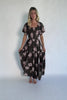 Dark olive floral maxi dress with a smocked bodice, square neckline, flutter sleeves, and a tiered ruffle skirt.