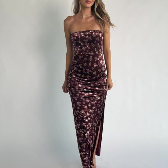 Berry floral velvet strapless maxi dress with side ruching, thigh-high slit, silicone grip neckline, and hidden back zipper.