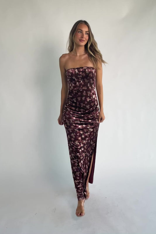 Berry floral velvet strapless maxi dress with side ruching, thigh-high slit, silicone grip neckline, and hidden back zipper.