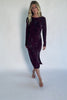 Model wearing a dark plum velvet floral midi dress with a boat neckline, long sleeves, and a fitted silhouette.