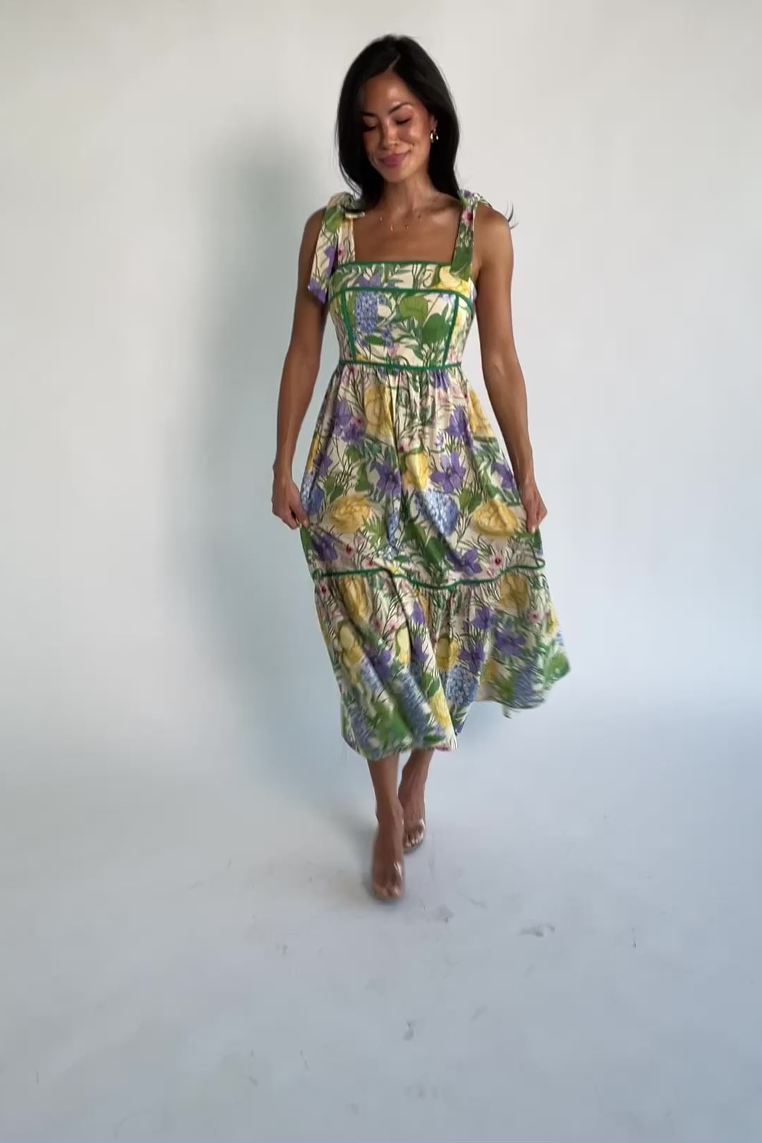 Model wearing the Torres Midi Dress featuring a multicolor floral print with green accents.
