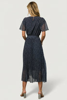 Back view of Prim Pleated Midi Dress showing button-and-keyhole closure, elastic gathering at waist, and removable self-tie detail.