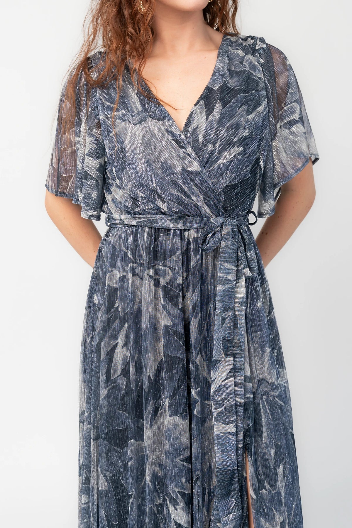 Rachel Maxi Dress in Blue Multi with silver shimmer leaves, surplice neckline, sash waist, and leg slit.