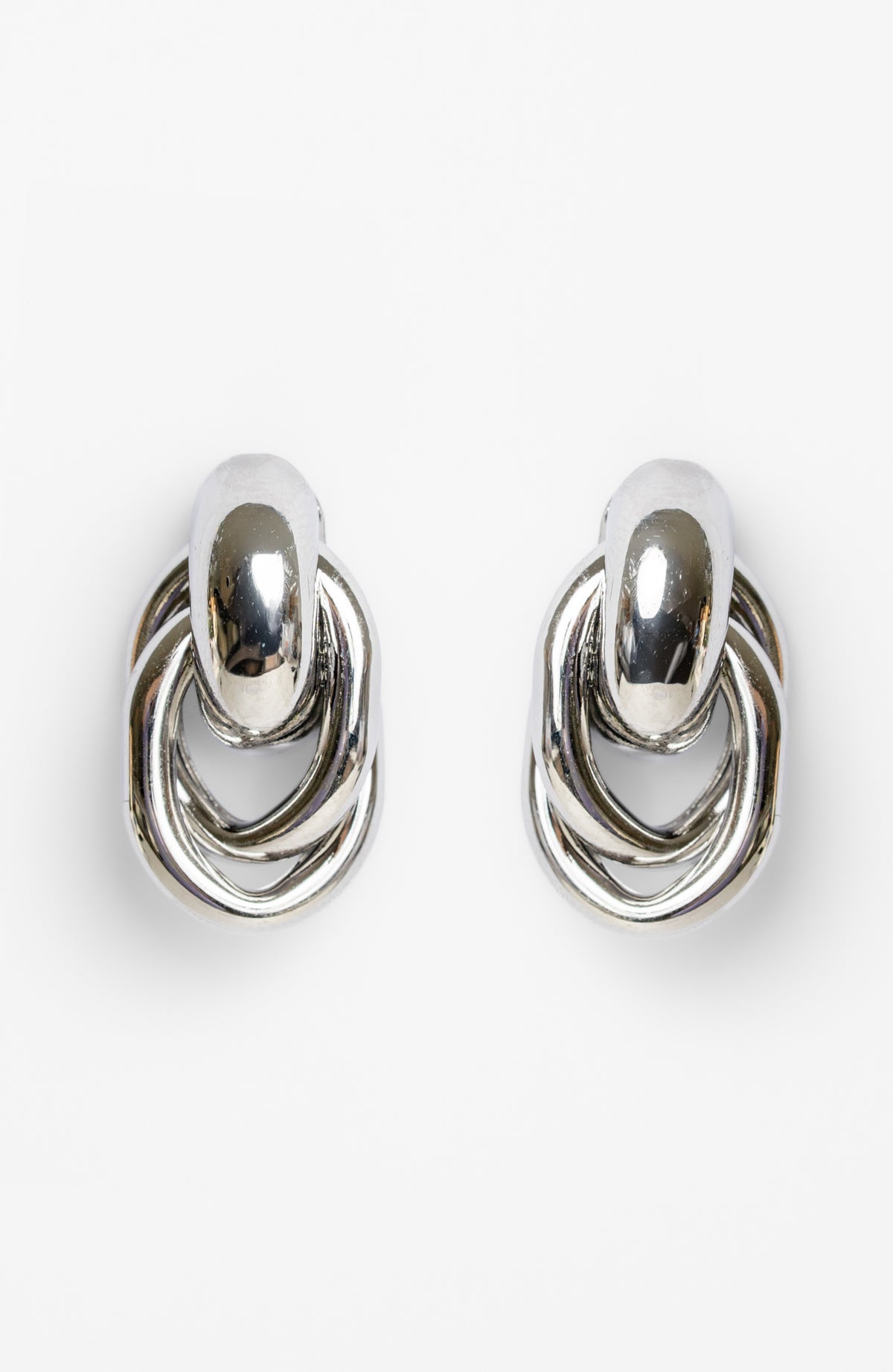 Revita Statement Earrings in Silver with bold interlocking design and polished finish.