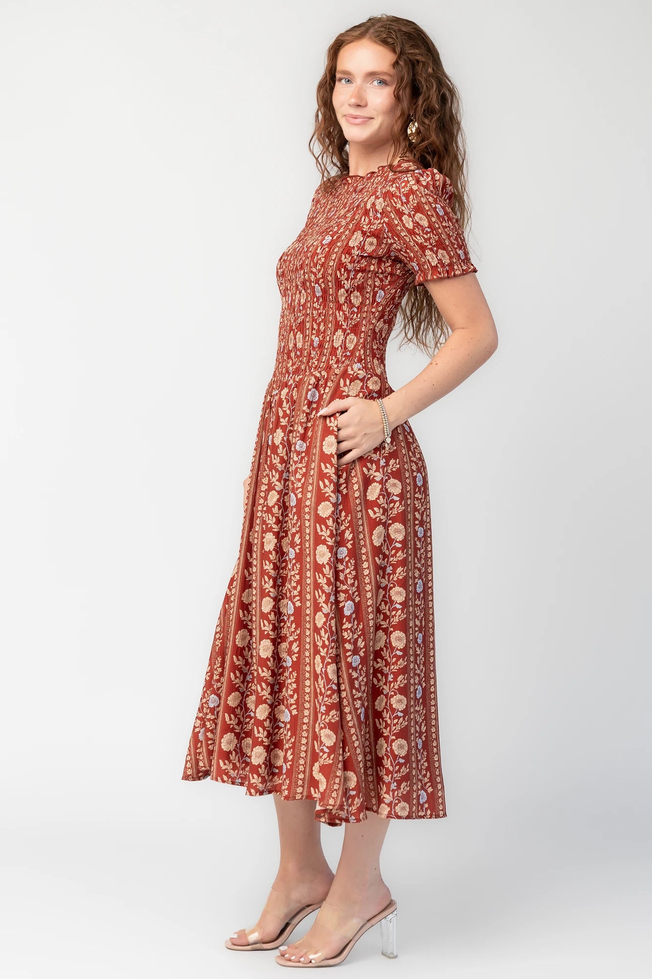 Rhonda Smocked Midi Dress in Rust Print with smocked bodice, short sleeves, round neckline, and gathered skirt.