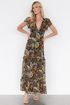 Model wearing the maxi dress in a front pose, showing overall fit, length, ruffle tiers, and graceful movement.
