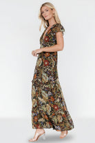 Close-up of textured chiffon and dotted shimmer with multi-color floral details and smocked shoulder trim.