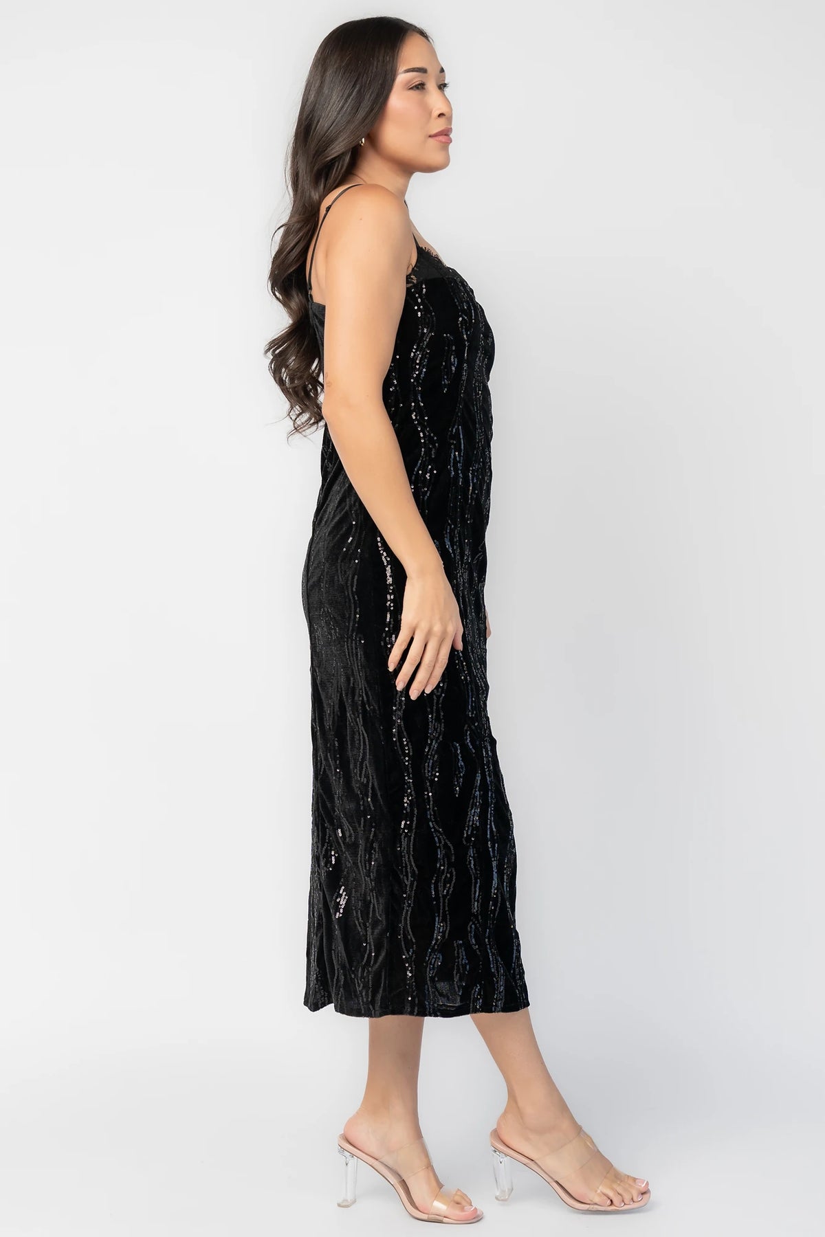 Sabina Sequin Midi Dress in Black with allover sequins, black lace neckline, spaghetti straps, and fitted silhouette.