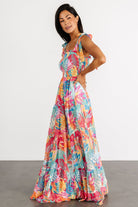 Back view of Santana maxi dress highlighting full skirt, gathered tiers, and smooth fully lined polyester fabric in tropical print.