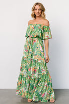 Styled flat-lay of Sonoma Off-Shoulder Maxi Dress in Green Multi, highlighting tropical print layout, removable belt, and full lining.