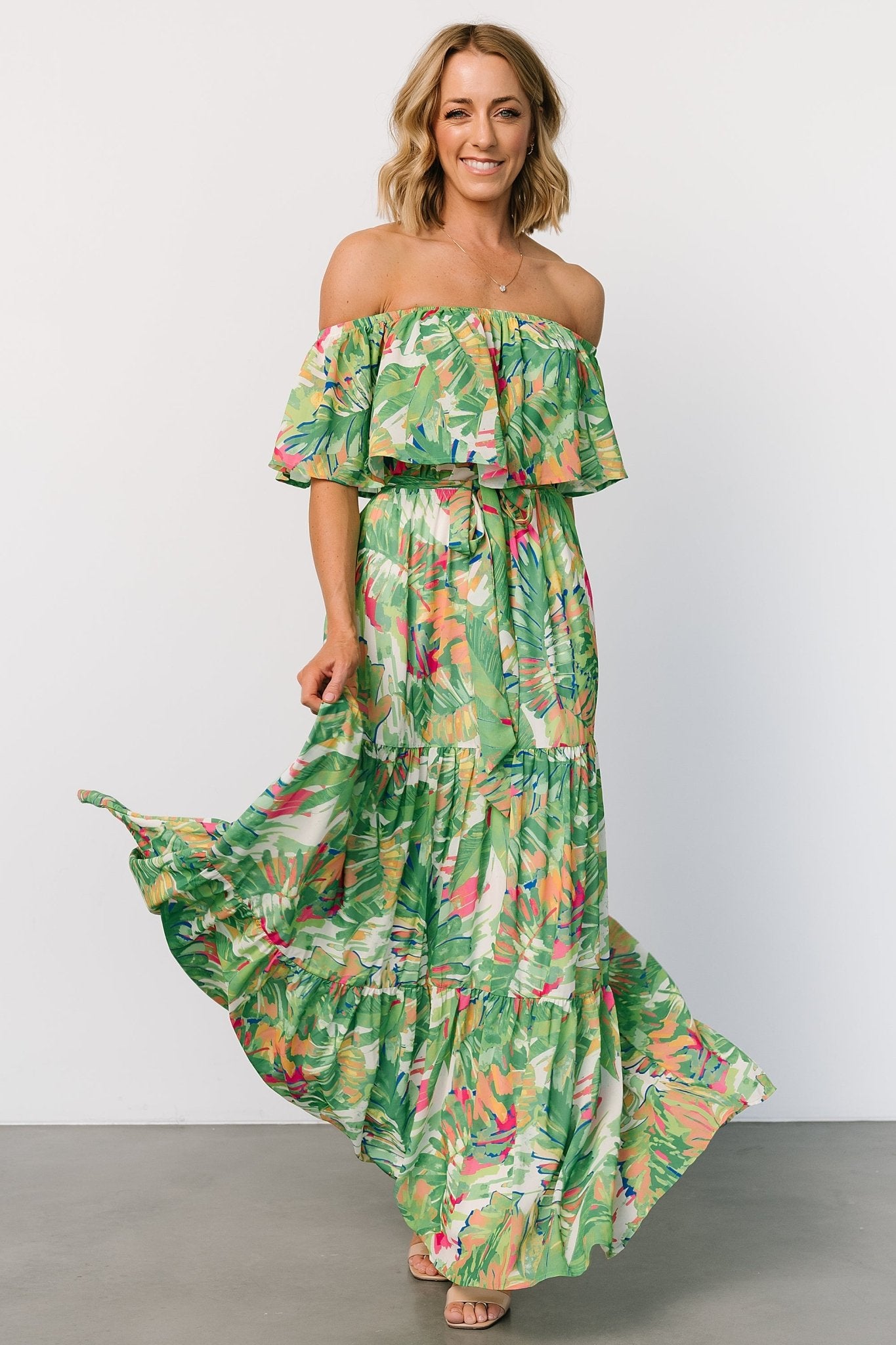 Side view of Sonoma maxi dress featuring off-shoulder silhouette, tiered hem movement, and fully lined construction for coverage.