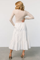 Back view of Sophie Sweater Dress in Natural showing seam lines and tiered skirt construction.