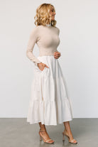 Full-length image of Sophie Sweater Dress in Natural showing flow of three-tier maxi skirt and overall silhouette.