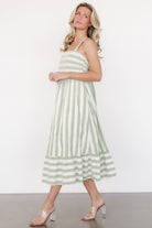 Fabric close-up of heather sage and cream stripe woven material with smooth lining visible at the skirt hem.